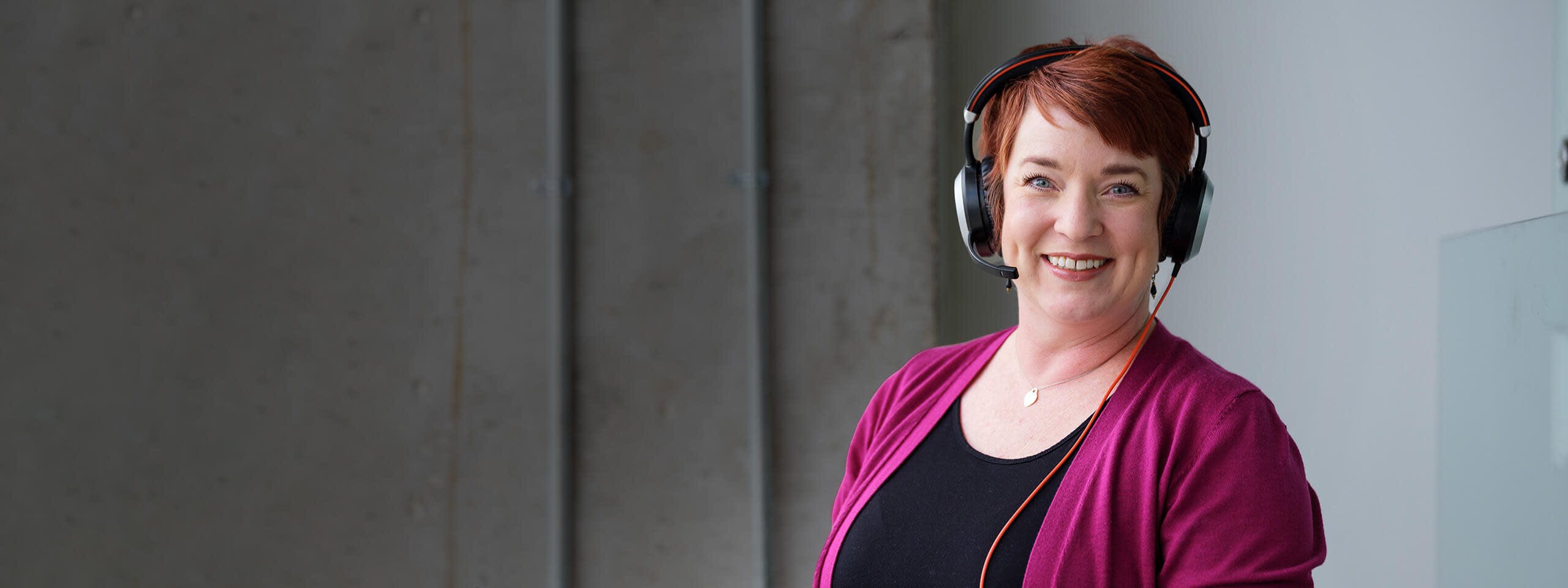 Woman with headphones on smiling to the camera